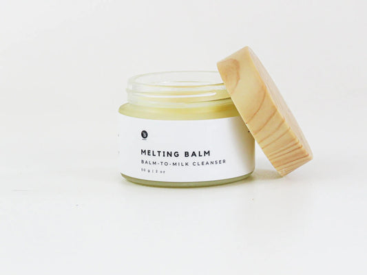 Bubble Gallery Melting Balm cleanser in a glass jar with a wooden lid, for all skin types.