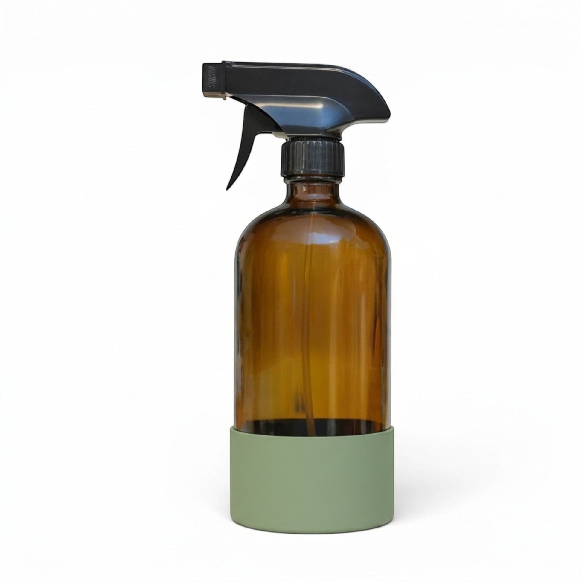 Bubble Gallery refillable amber glass spray bottle with a black trigger sprayer and protective sage green silicone base.