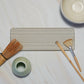 Bubble Gallery diatomaceous earth bottle tray in neutral grey with horizontal channels. Holds two soap dispensers and a bar.