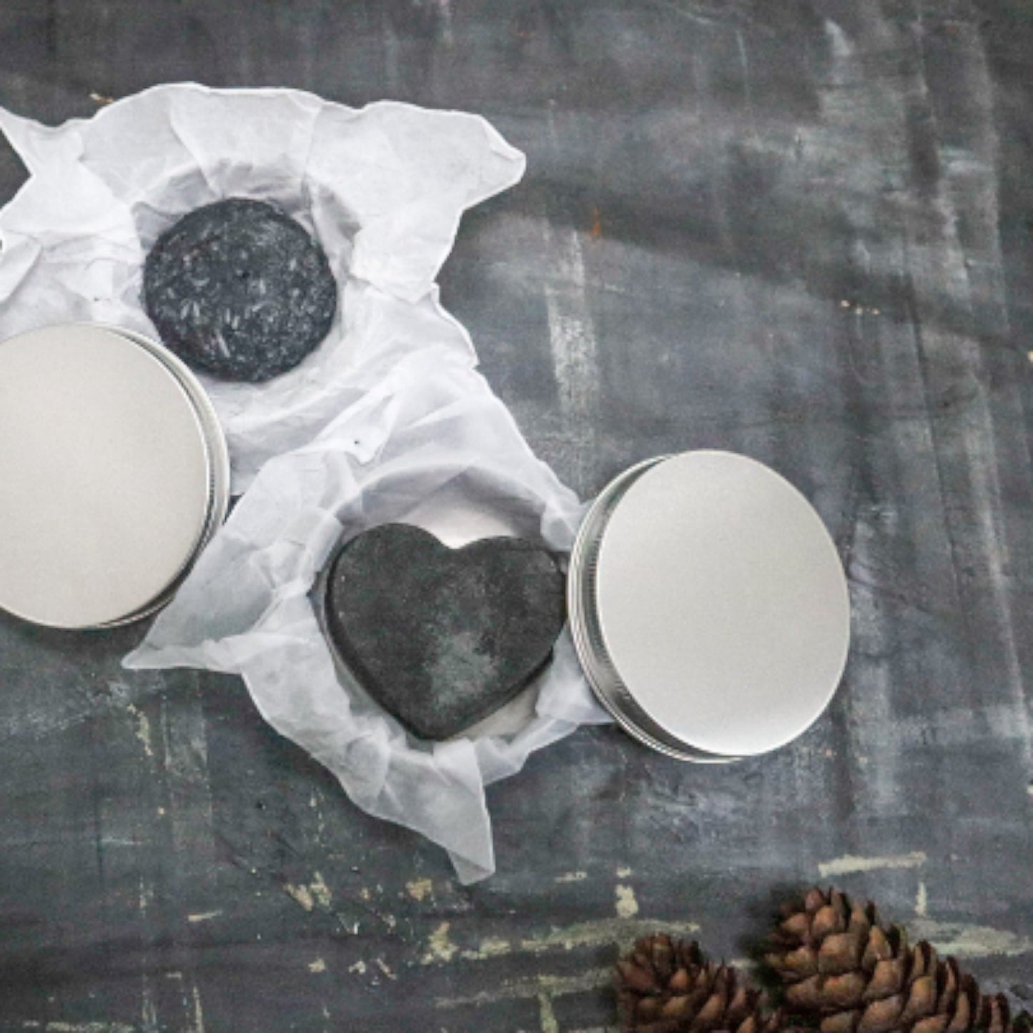 Bubble Gallery rebalancing shampoo and conditioner bar set with round and heart-shaped bars in metal tins.