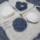 Bubble Gallery rebalancing shampoo and conditioner bars in round and heart shapes with natural sisal soap saver bags.