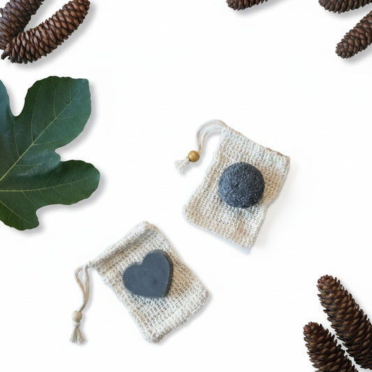 Bubble Gallery rebalancing shampoo and conditioner bar set with round and heart-shaped bars in small cotton bags.