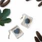 Bubble Gallery rebalancing shampoo and conditioner bar set with round and heart-shaped bars in small cotton bags.