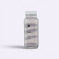 Bubble Gallery Wild Lavender Bubbling Magnesium Bath Soak in a glass jar with white lid, layered purple and white salts.